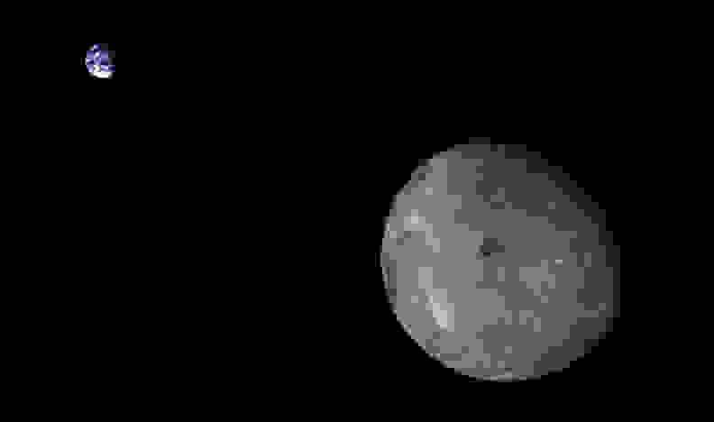 The far side of the moon with the Earth in the background.