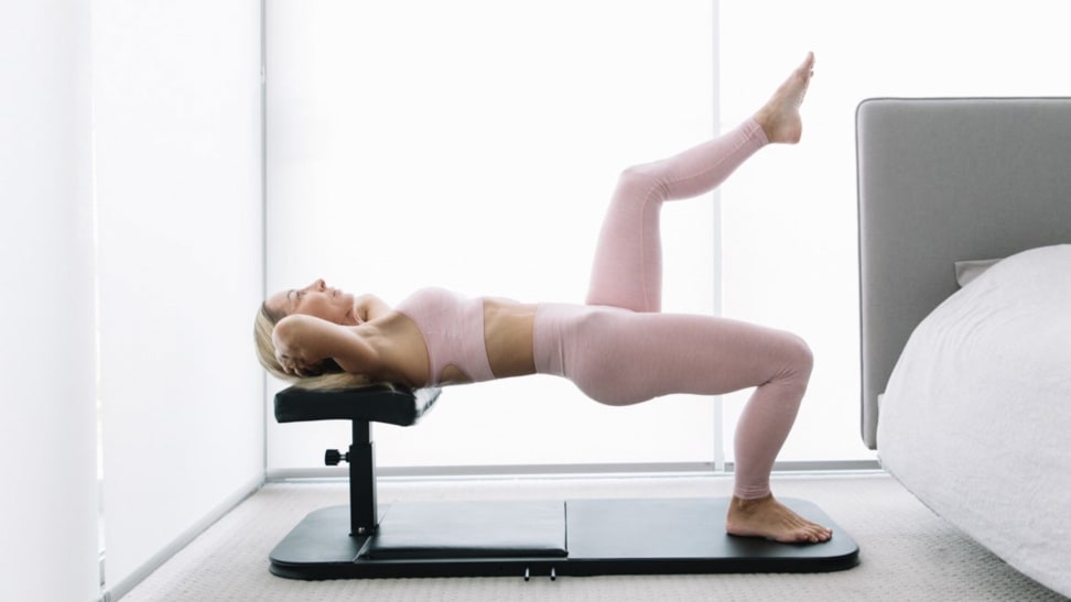 A woman doing single leg hip thrusts with the BaseBench.