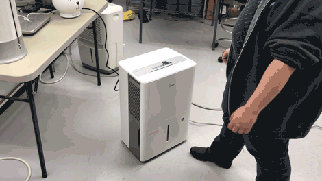 video of a person pushing a button on a dehumidifier