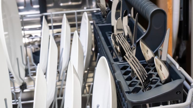The Vinotemp Brama BR-DWSH01-S dishwasher's cutlery basket, lined with silverware.