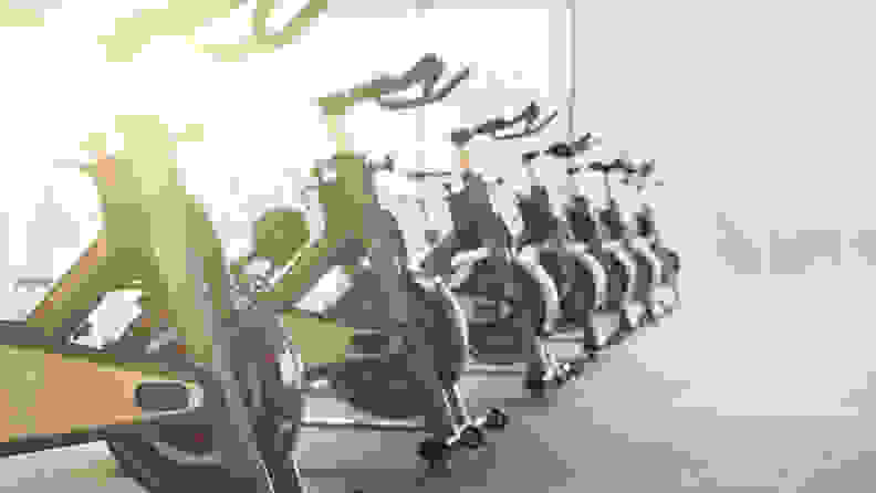 Modern gym interior with equipment. Fitness club with row of training exercise bikes. Healthy lifestyle concept