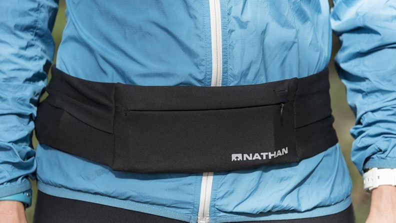 Person wearing Nathan Zipster running belt.