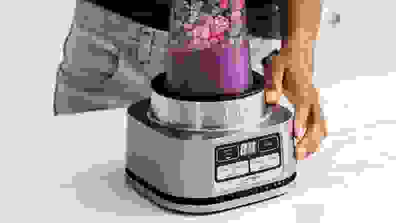 A closeup of a Ninja smoothie bowl maker and nutrient extractor in use.
