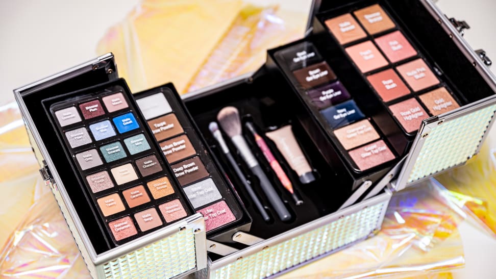 A box full of makeup powders and creams.