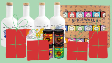 White bottles, a spice box, and other sauces on a green background with red presents