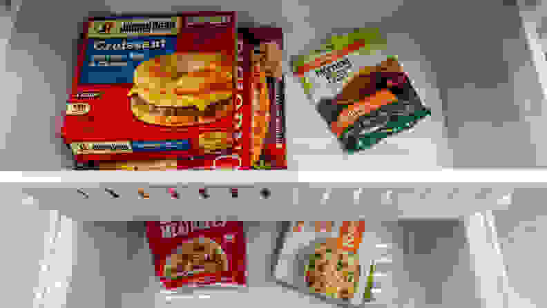 A close-up of the fridge's freezer drawer, with both its main bit and upper drawer filled with frozen foods.