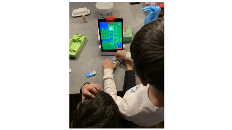 Kids love navigating through Awbie's word with coding blocks in Osmo Coding Awbie..