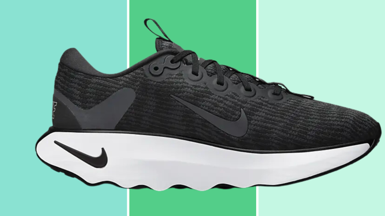 Black Nike Motiva sneaker on a green background