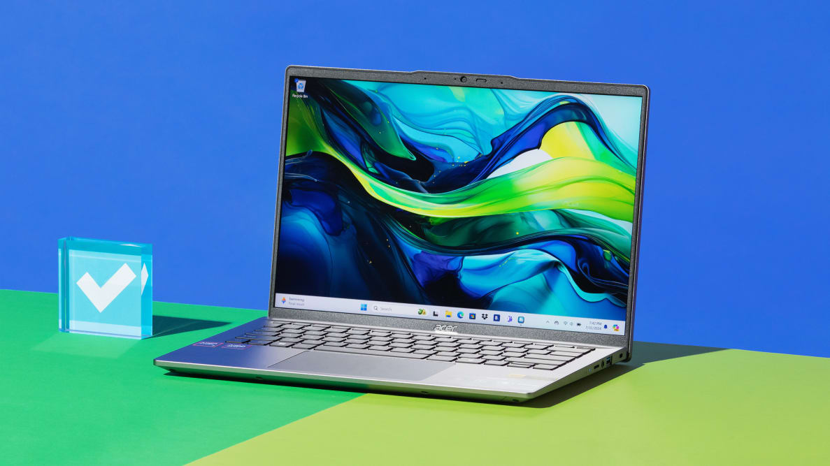 The 2024 version of the Acer Swift Go 14 laptop sitting on top on green contrast surface.