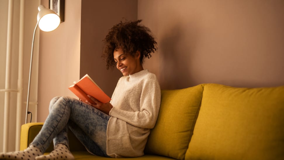 Woman reading a book on a couch