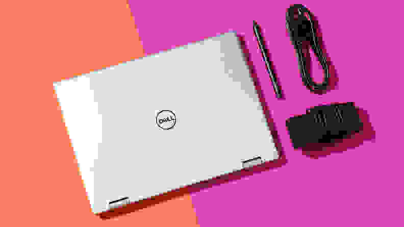 A closed Dell Inspiron 14 7420 arrayed with stylus and charger cord.