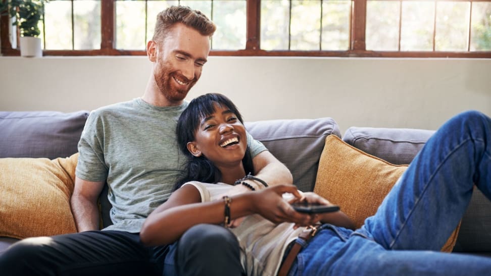 A couple relaxing on a couch at home