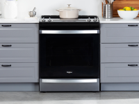 The Whirlpool WEE745H0LZ Electric Range in a modern kitchen between two sets of drawers.
