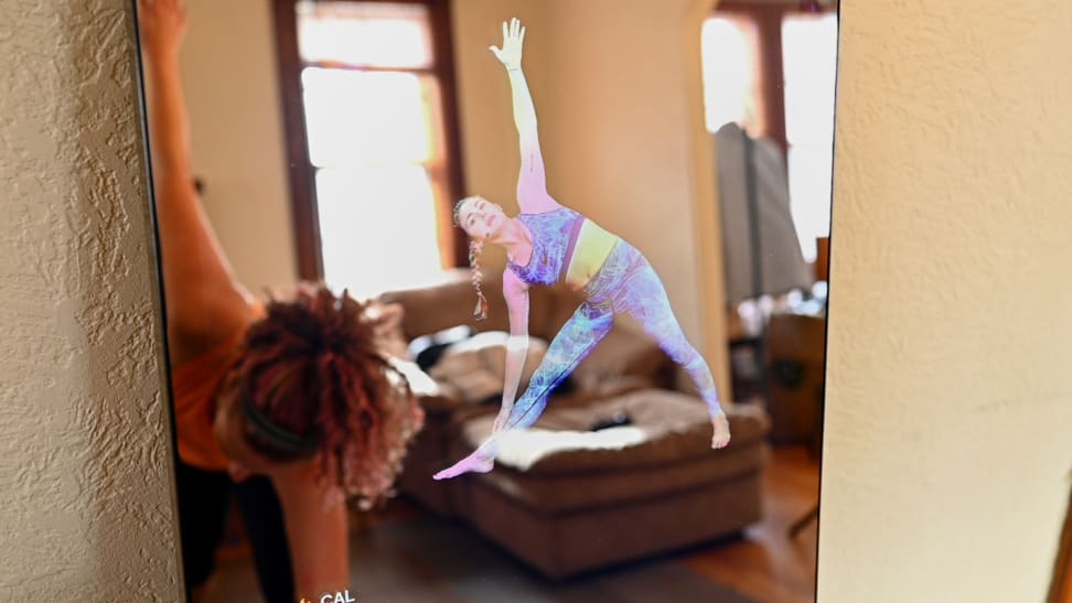 Woman doing yoga in front of lululemon Mirror.