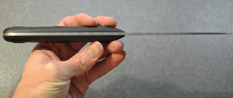 A full tang extends from the front of the handle to the back.