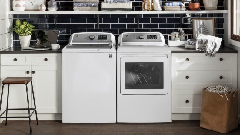 A white GE GTW720BSNWS top-load washing machine and matching dryer sit in a laundry room