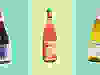 Assorted wine bottles on green and blue background.