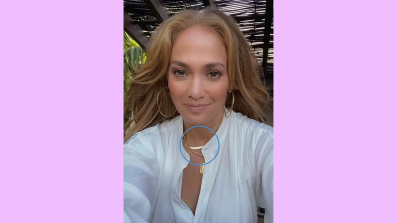 Jennifer Lopez wearing white shirt and gold jewelry