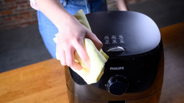 Wiping down an air fryer