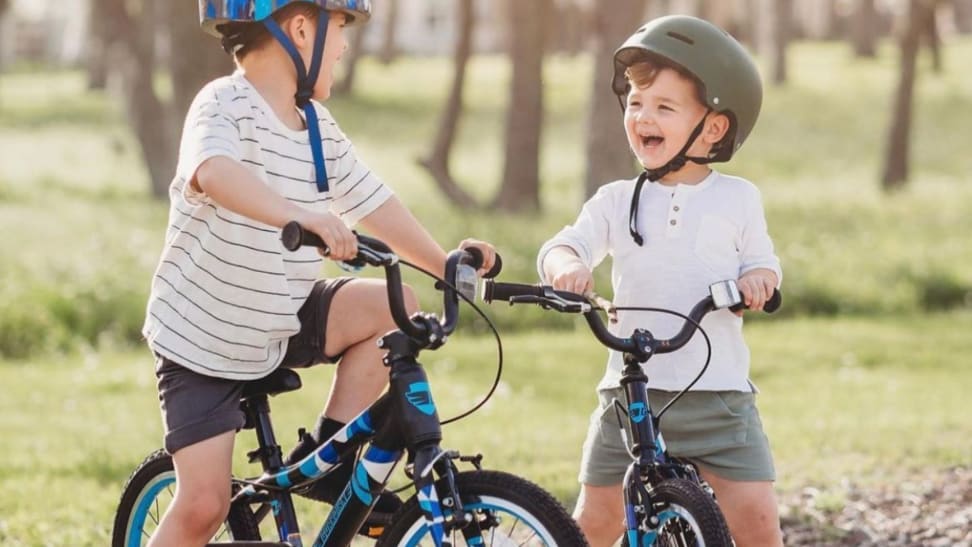 Two children laugh as they sit on their Guardian Kids Bikes