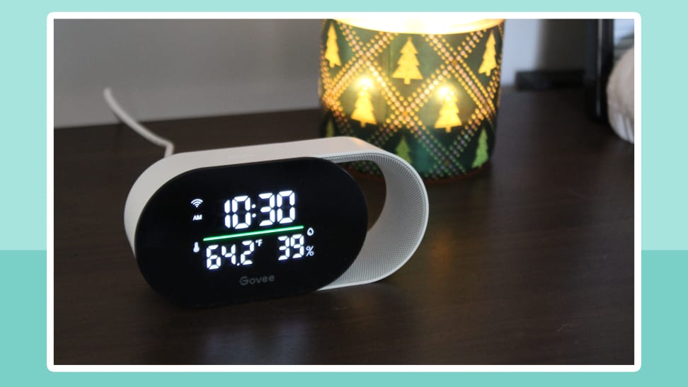 The Govee Smart Air Quality Monitor sits on a nightstand with the time and data displayed on a digital screen