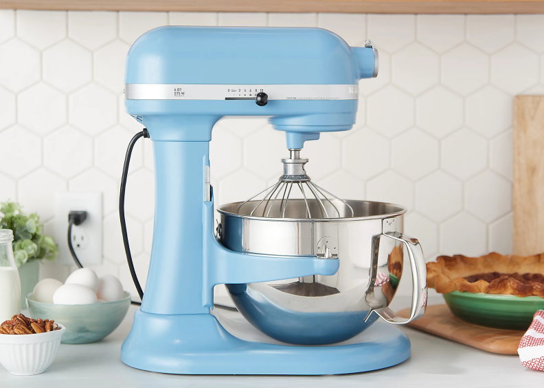A light blue stand mixer on a kitchen backdrop.
