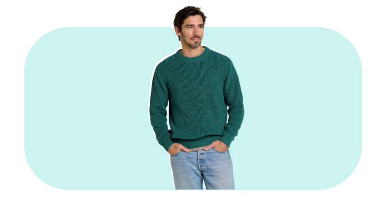 A model wearing a green sweater.