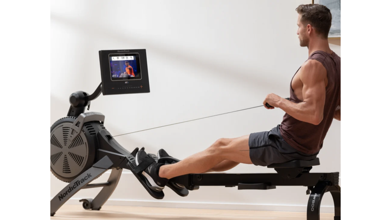 A man uses a rowing machine
