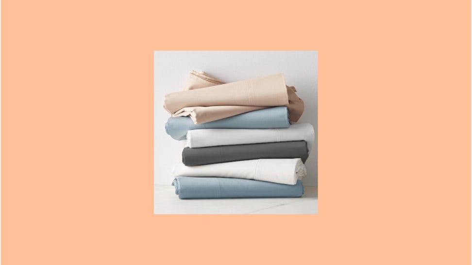 A stack of blue, white, black, and beige pillowcases set on an orange background