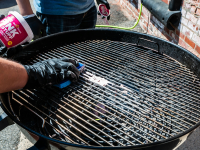 The Pink Stuff all-purpose cleaner is applied to a grill by hand.
