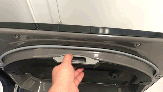 Person using hand to open and close the Fabric Refresh reservoir on GE Profile 900 Series PTD90EBPTRS Dryer.