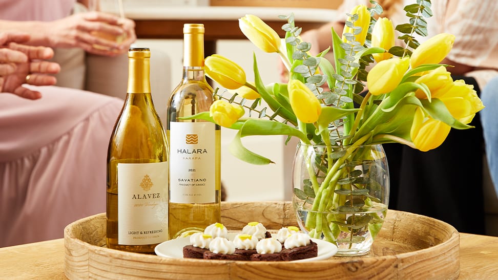 white wine on tray next to yellow flowers