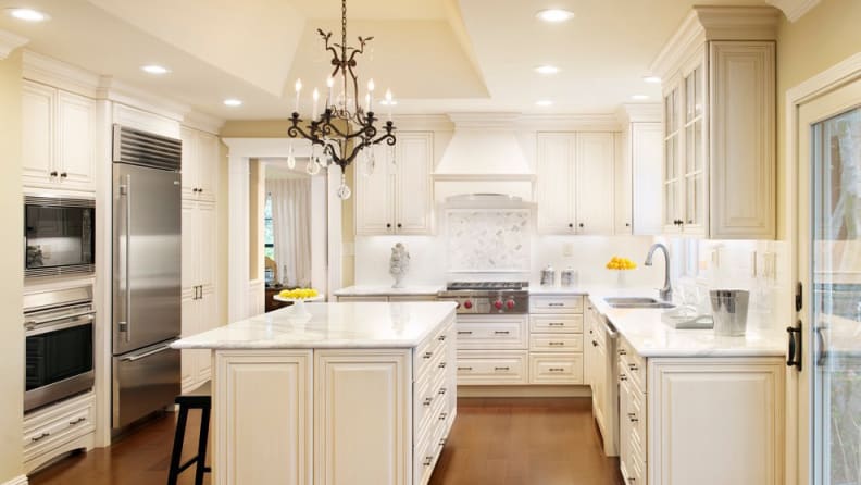 The millwork on the range hood blends seamlessly into the cabinetry. The cooktop knobs are permanent accents in this kitchen.
