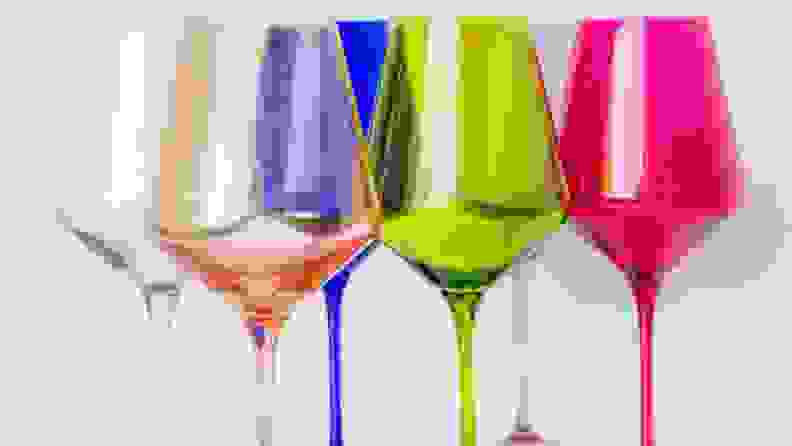 Six wine glasses, each in different shades including seafood green, light pink, dark blue, chartreuse, violet, and fuchsia.