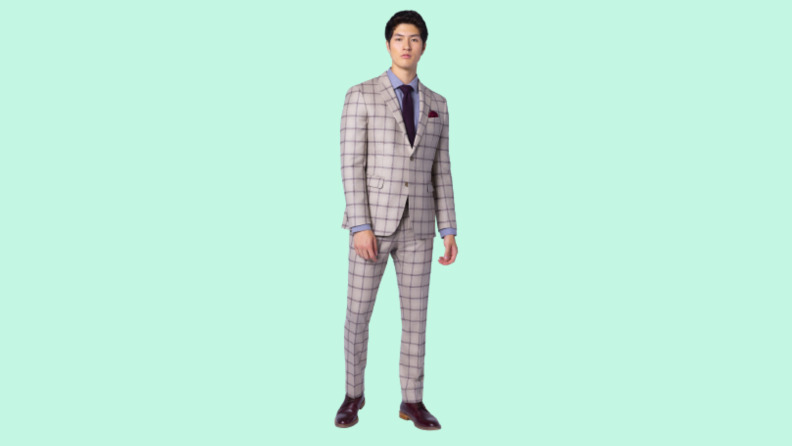 A model wearing a plaid purple suit.