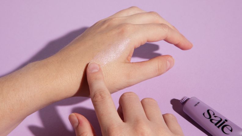 Dew Balm being applied to a hand.