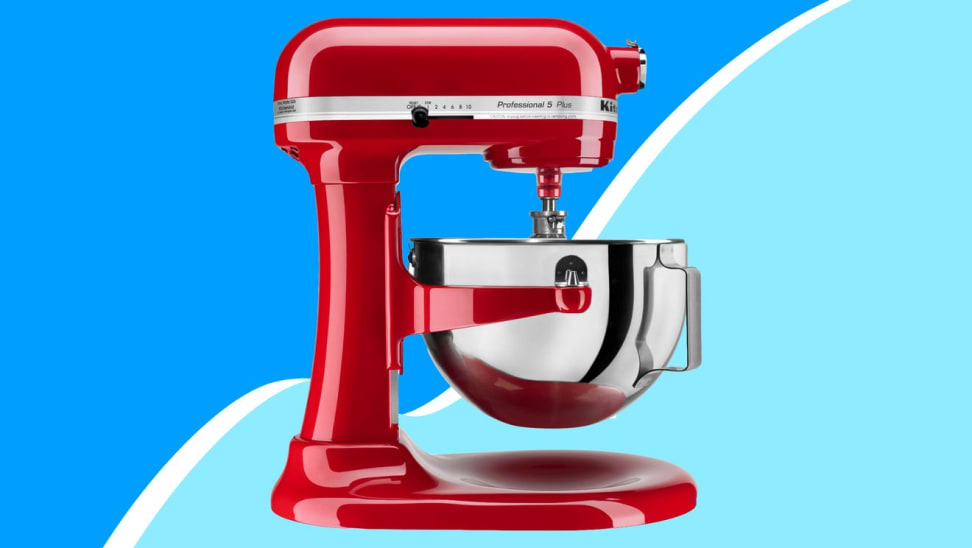 Red standing mixer in front of blue background.