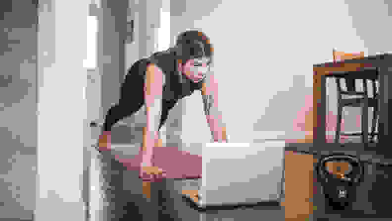 A woman doing a plank on a yoga mat.