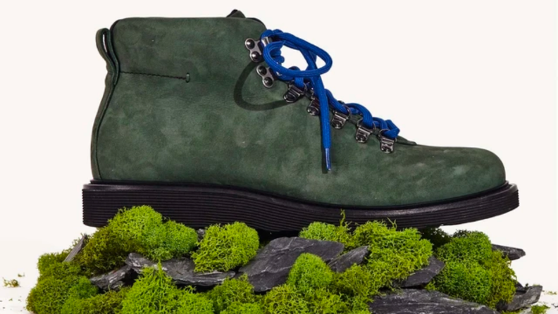 A green boot atop a mossy pile of rocks.