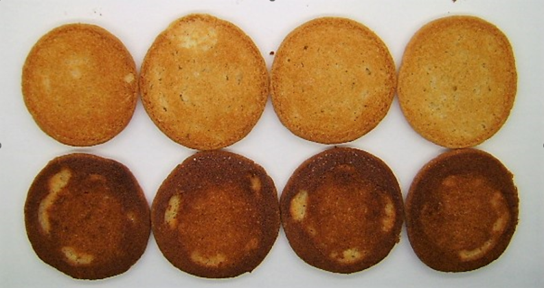 Two rows of four cookies, each different in color, show the Maytag MER7700LZ's baking unevenness.