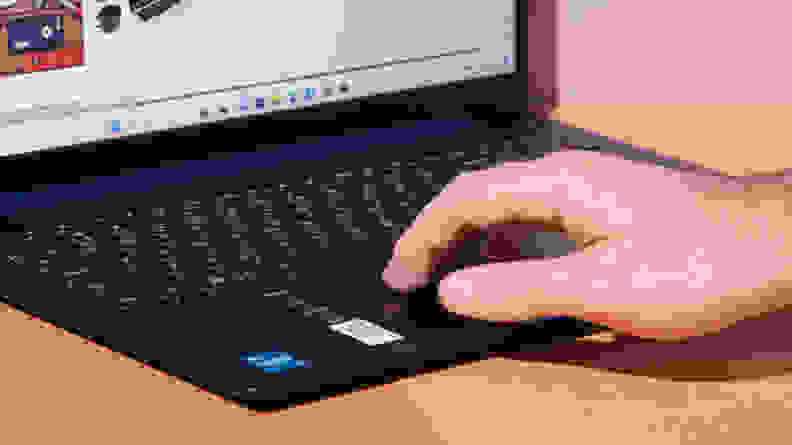 A person's hand  using the trackpad on a laptop.