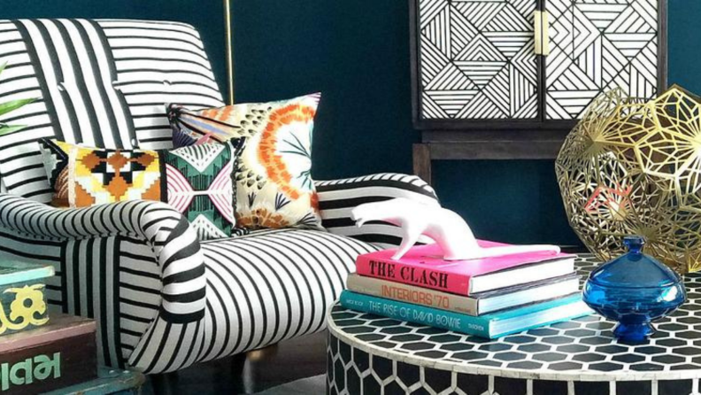 A boldly patterned chair and rounded coffee table