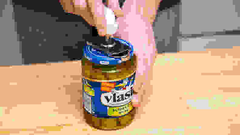Close-up of a tester opening a jar of Vlasic pickle spears.