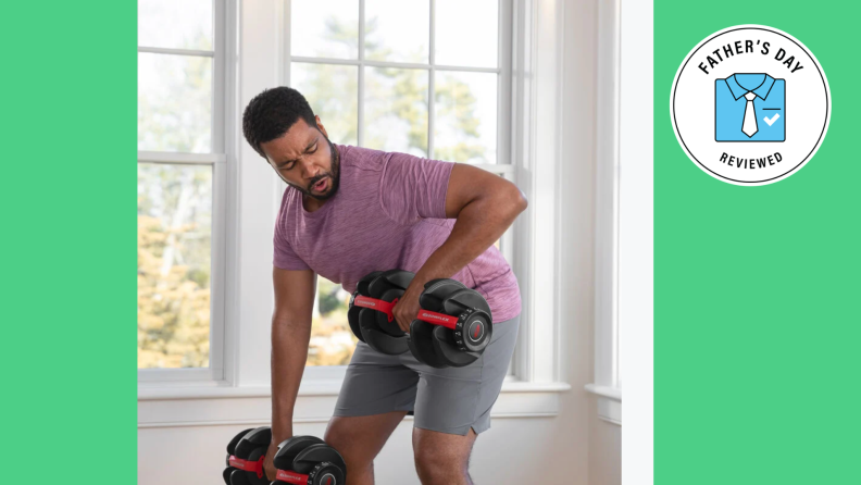 A Black man uses his adjustable Bowflex weights