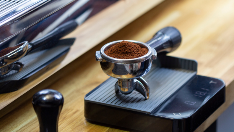 Espresso is weighed on a kitchen scale.