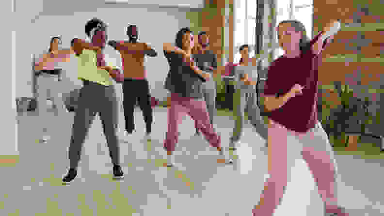 A group of people taking a dance workout class.