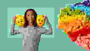 A girl holding two Lego heads on her shoulders next to a rainbow-colored pile of Legos.