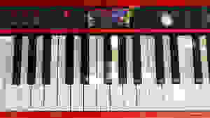 A closeup of a red Roland piano keyboard, with black and white keys