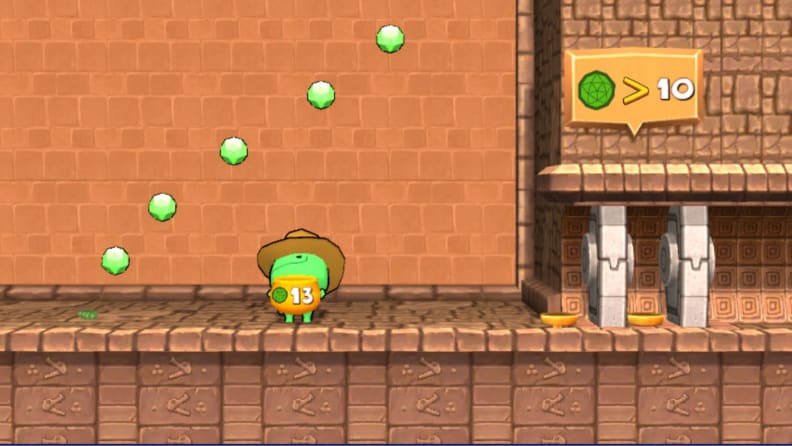 A small green character collects green gemstones in a basket