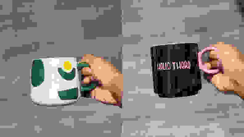 Green, white, and gold avocado mug and black mug with 'Hello There' written in pink text by Tabitha Brown for Target